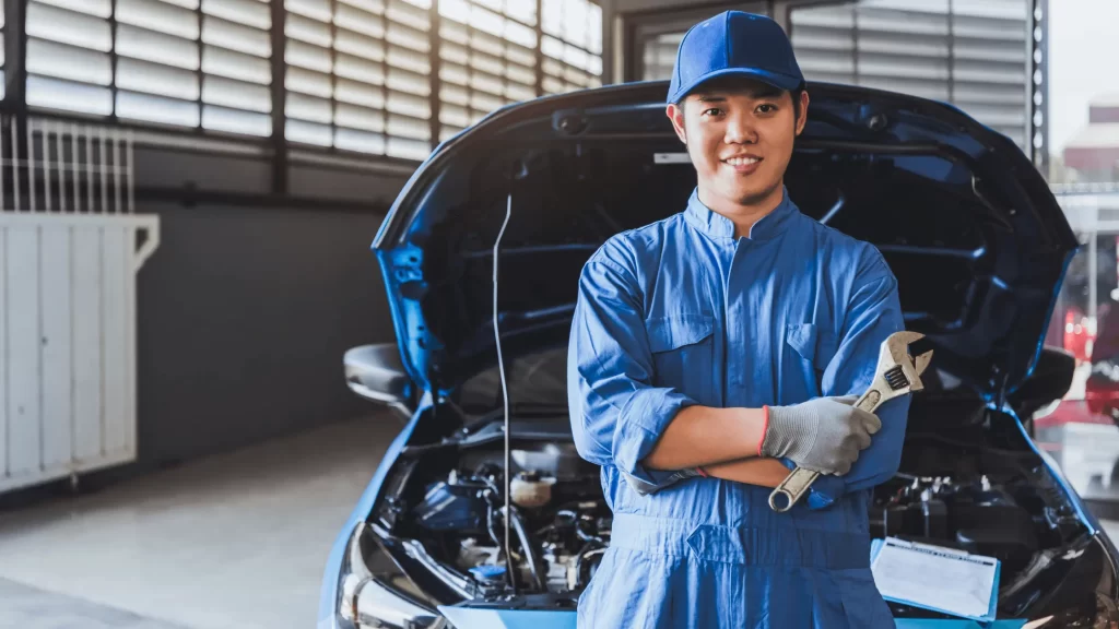 A mobile mechanic stand up in front of a car
