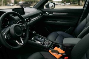 Interior view of a car featuring a sleek black leather seat, highlighting the importance of maintaining upholstery in Dallas.